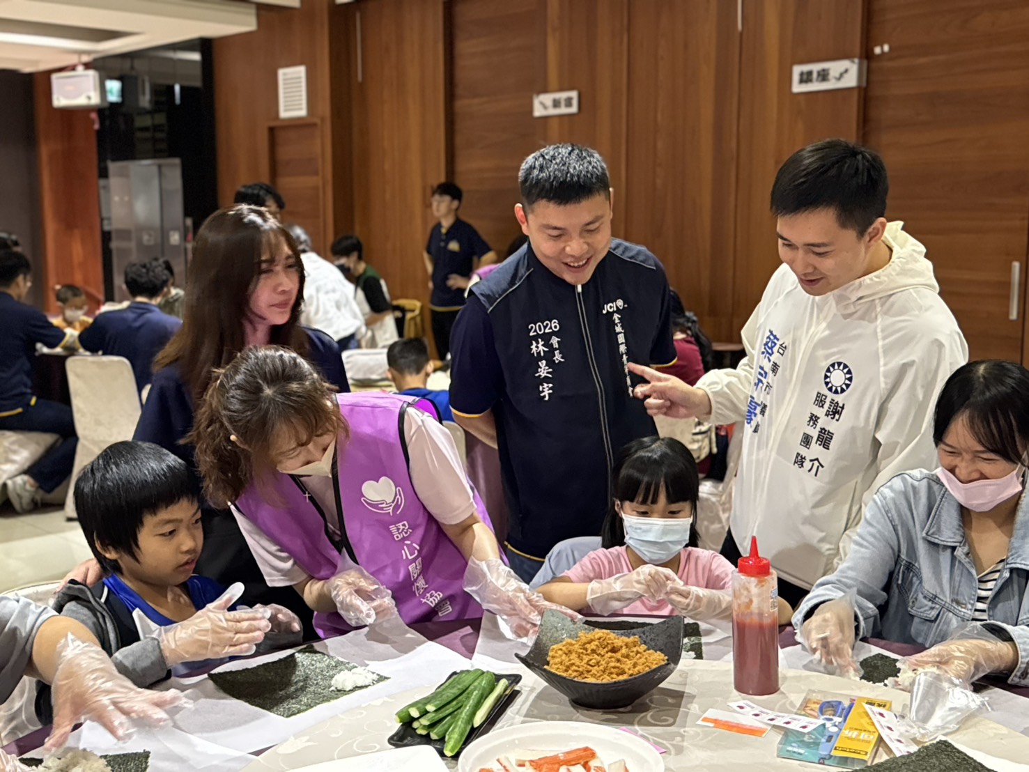 志工與家長陪伴孩子完成壽司製作，讓活動成為親子互動的暑期時光。（圖／主辦單位提供）